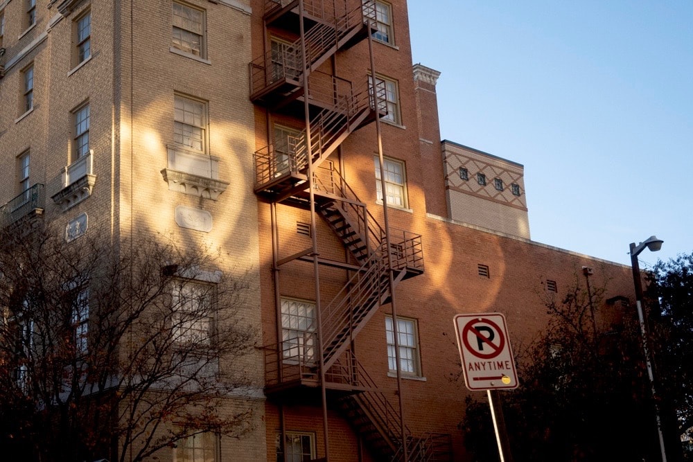 Person sitting by window working on tablet