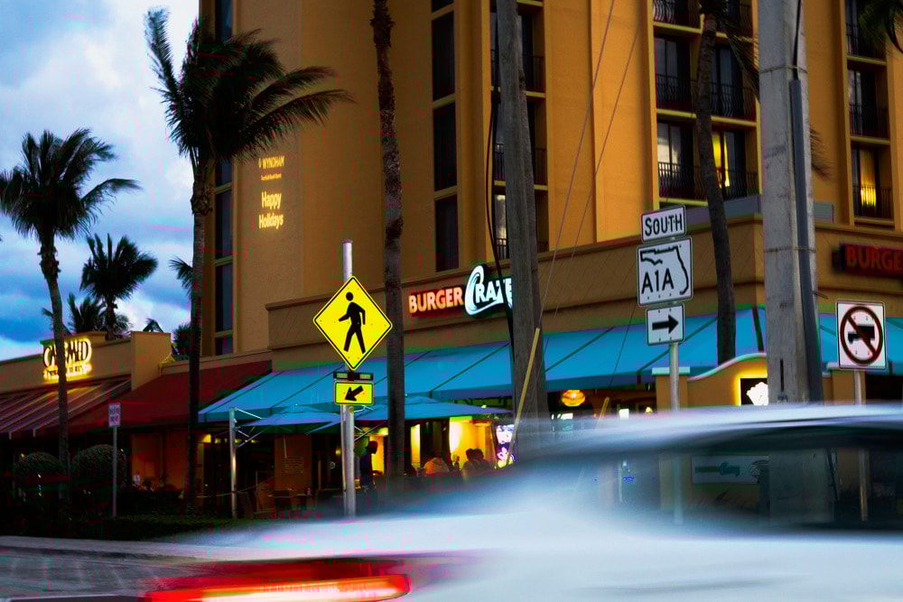 Person at standing desk working on laptop
